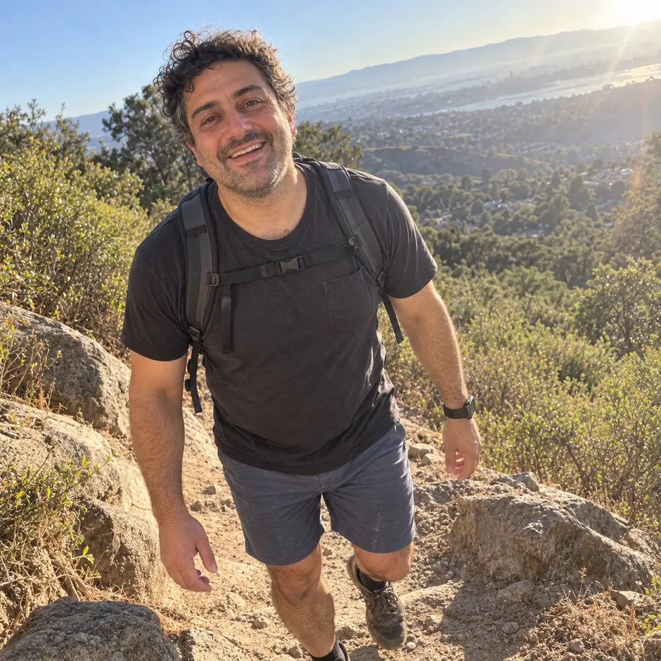 AI-generated example of a future self: a man laughing on a morning hike in golden light, a small pack on his back.
